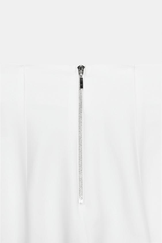 Pantalon taille haute à fermeture zippée au dos