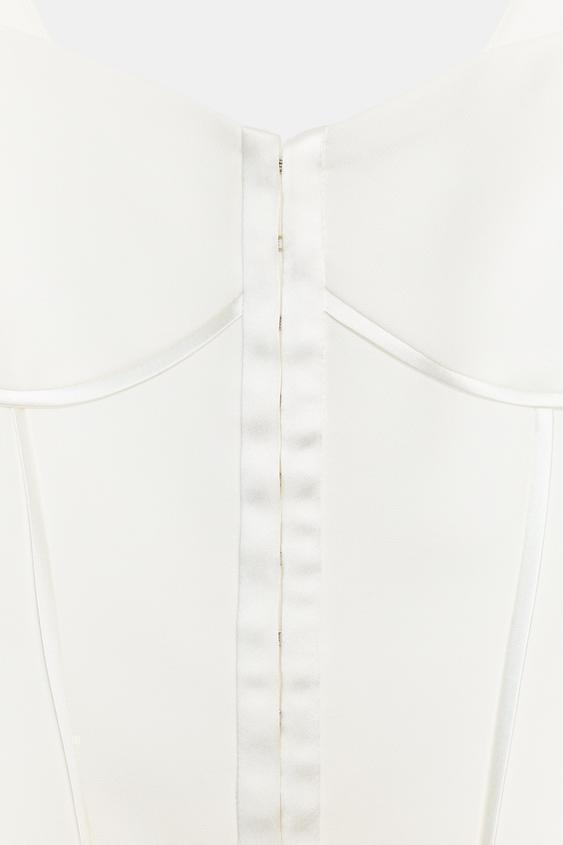 Top bustier à passepoils satinés
