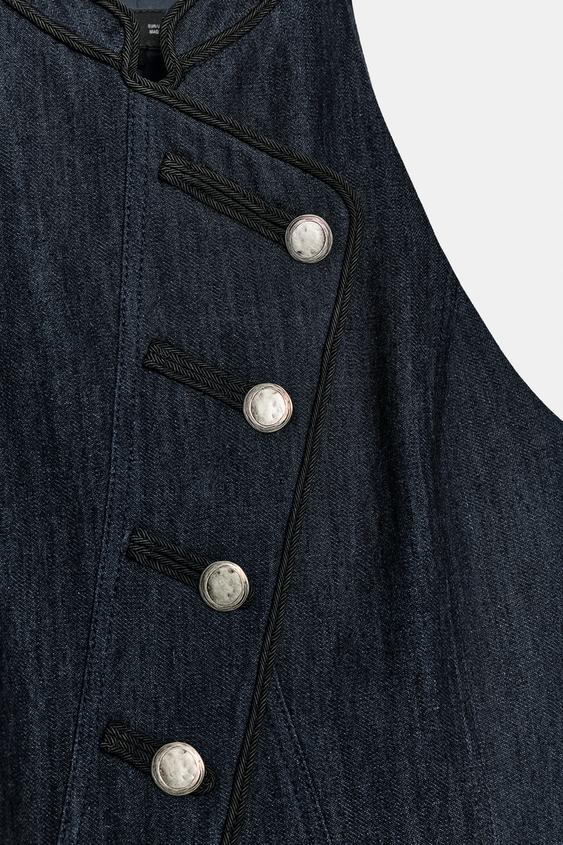 Gilet dos-nu à passepoils contrastés