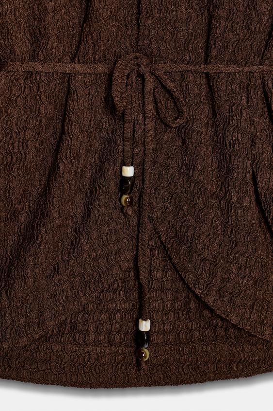Veste avec ceinture effet froissé