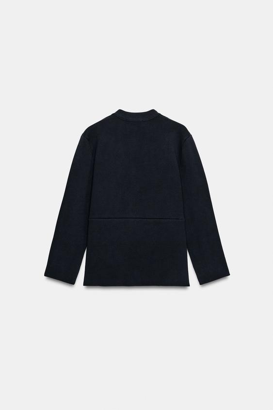 Veste en maille peplum à bouton doré