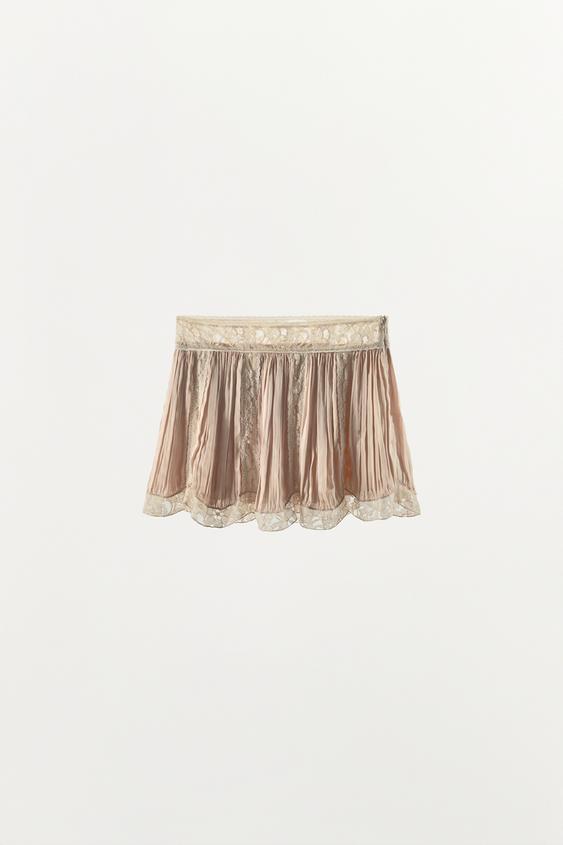 Jupe mini plissée en dentelle à perles