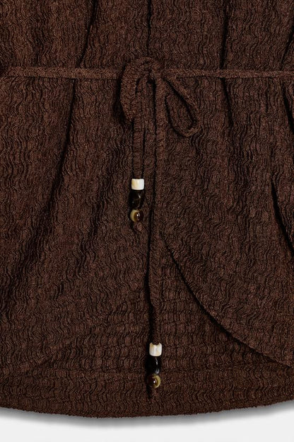 Veste avec ceinture effet froissé